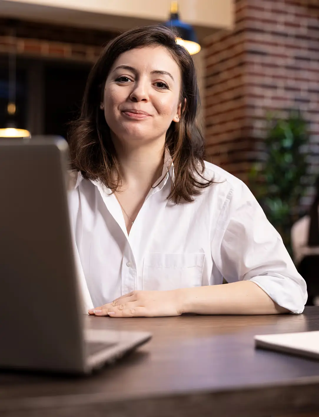 Professional smiling while working on a laptop