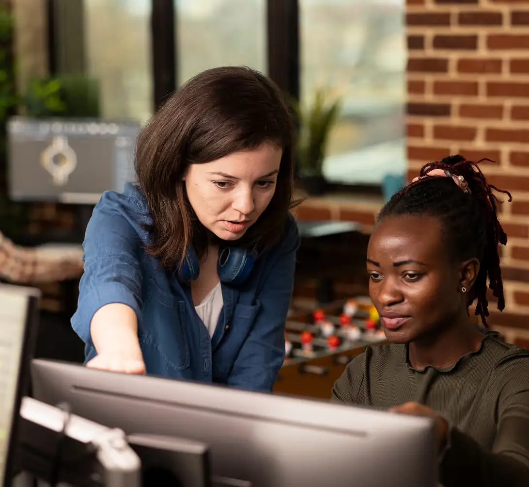 Team members working together at a computer
