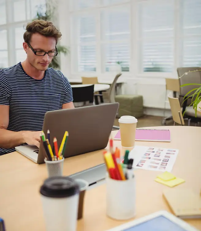 Professional working on a laptop at a desk