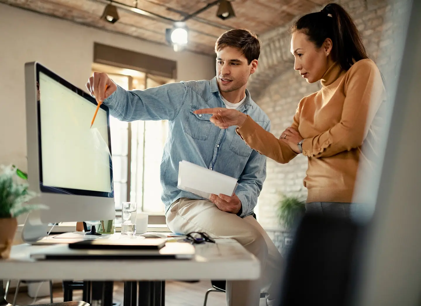 Colleagues working together at a computer