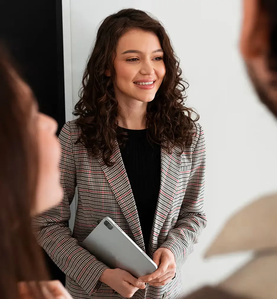Professional holding a tablet in an office
